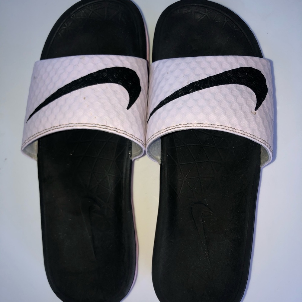 Pink and black nike slides